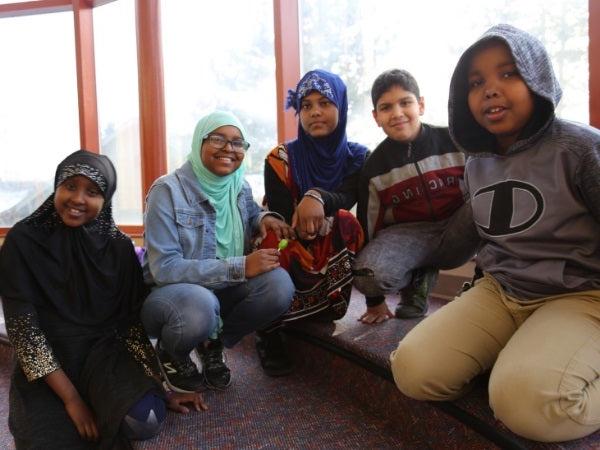 Five Rising Star students sit together and smile for a photo